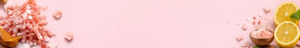Pink Himalayan salt rocks and fresh lemon slices banner